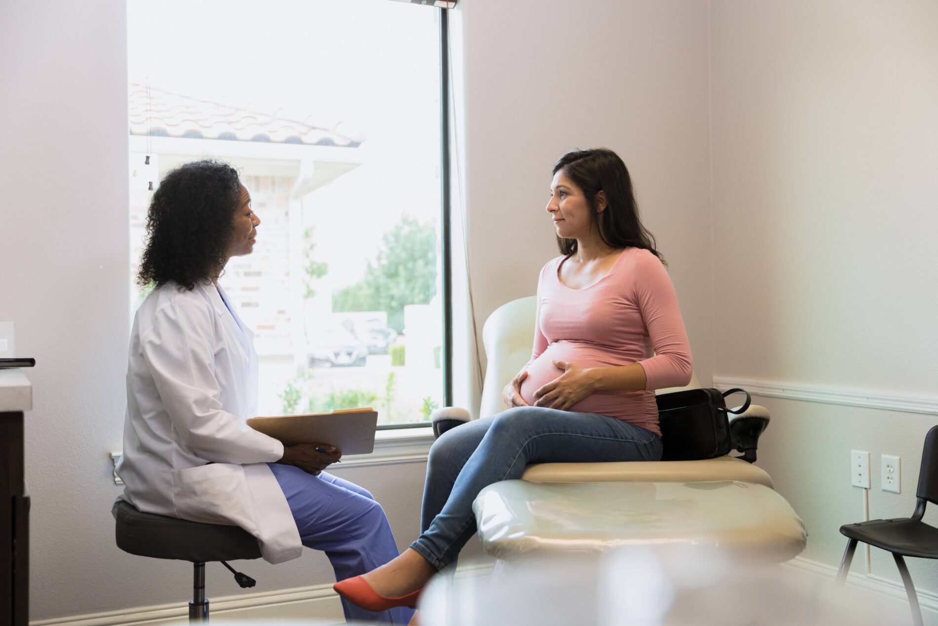 Pregnant woman talking to doctor